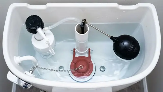 Inside of a toilet tank showing the fill valve, float and flapper